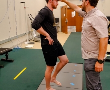 A subject’s brain activity is monitored as he balances as part of a course of rehabilitative ankle exercises. Dr. Alan Needle, associate professor in Appalachian State University's Department of Health and Exercise Science, right, is hoping his research will lead to a decrease in recurrent ankle injuries.