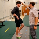 A subject’s brain activity is monitored as he balances as part of a course of rehabilitative ankle exercises. Dr. Alan Needle, associate professor in Appalachian State University's Department of Health and Exercise Science, right, is hoping his research will lead to a decrease in recurrent ankle injuries.